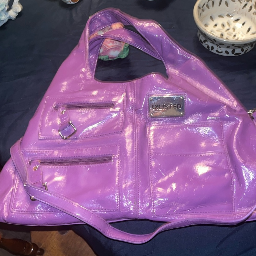 Unlisted by Kenneth Cole, Purple bag. Good used condition.